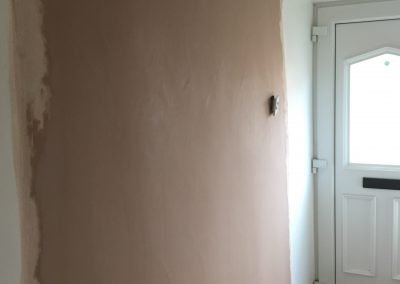 Hallway door closed off and plastered