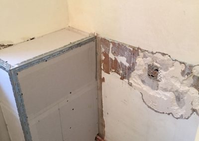 Tiles removed and pipes boxed in